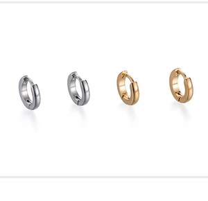 Detailed close-up of minimalist stainless steel hoop earrings in gold and silver finishes