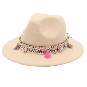 Detail of bohemian fedora with ethnic woven band, colorful tassels and natural shells