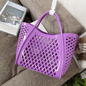 Detail of a purple silicone hollow tote bag on a sofa, highlighting its glossy texture