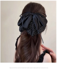 Detail showing high-quality black silk satin layered bow clip on hair from the back