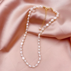 Baroque natural freshwater pearl necklace with 14k gold plated lobster clasp on pink silk