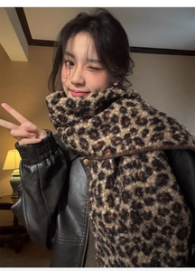 Detail of soft leopard print scarf in dark brown faux wool fabric for winter style