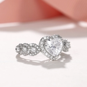 Elegant heart-shaped halo ring with twisted diamond band in silver-tone finish