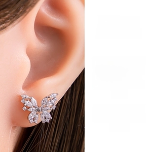 Macro view of butterfly ear stud with pavé-set marquise cubic zirconia details