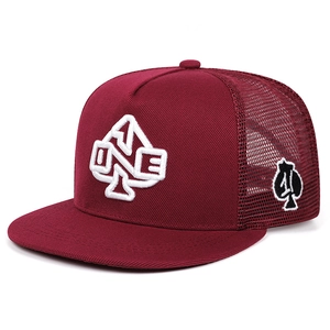Macro shot of 3D embroidery and breathable mesh on the burgundy hip-hop trucker hat