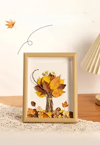 Macro detail of natural dried leaves and flowers in a wooden 3D shadow box frame