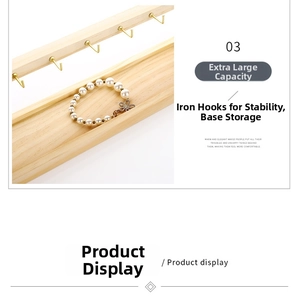 Detail of wooden jewelry stand with metal hooks and base slot for pearl bracelets