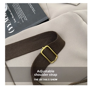 Detail of adjustable high-density brown woven strap with a gold rectangular metal buckle