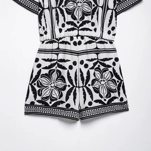 Bohemian black and white print romper with cuban collar and elastic waist flat lay