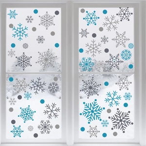 Blue and grey snowflake window decals with dots on glass with a snowy background