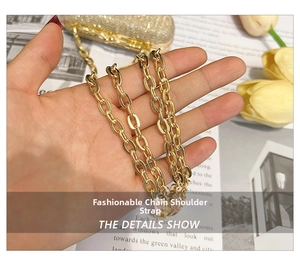 Detail of elegant gold metal chain strap on a textured luxury pink evening clutch bag