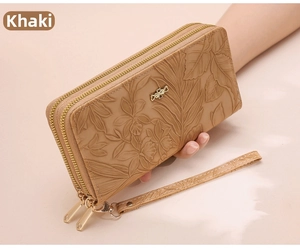 Detail of khaki leather wallet featuring floral embossing and a metal bow accent