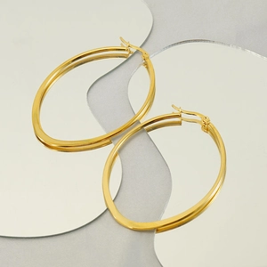 Detailed close-up of 18k gold plated stainless steel oval hoop earrings with secure clasps