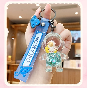 Blue astronaut liquid glitter keychain with dreamer silicone strap and planet charm