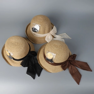 Three wide-brim straw hats in beige, black, and brown with elegant bow and pearl details