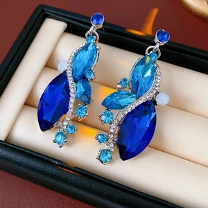 Detail of vintage marquise-cut blue crystal earrings in a jewelry gift box