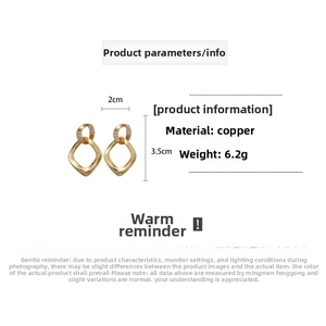 Detail view of twisted gold geometric earrings with zircon inlay and product dimensions