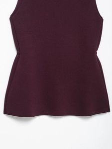 Detailed view of dark plum ribbed knit texture and slim-fit hem on a sleeveless top