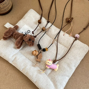 Handmade necklace pendants featuring plush puppy, wooden fish, and cat charms with beads