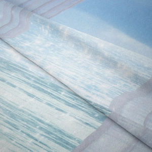 Close-up detail of soft blue abstract landscape tapestry fabric texture and drapery