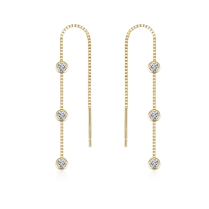 Macro view of gold S925 sterling silver tassel earrings with three sparkling zircons