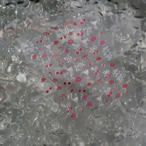 Detail of 5D embossed nail art stickers with pink lips, bows, and heart designs