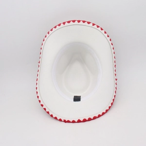 Interior detail of white cowboy hat showing red wave trim, sweatband and material label