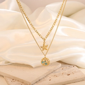 Gold double-layer necklace with starfish pendant and blue stone on white silk