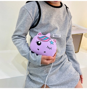 Detail of cute purple unicorn crossbody bag with colorful mane and braided shoulder strap