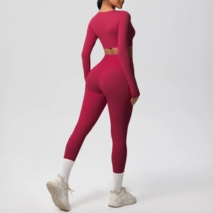 Close-up of the back view showing high-waist yoga pants and long sleeve crop top in red