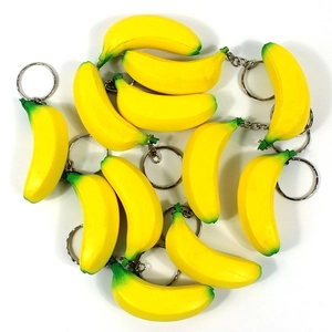Creative mini banana shaped keychains with silver metal rings on a white background