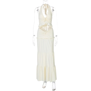 Detail of cream white two-piece set featuring ruffled halter neck top and layered maxi skirt