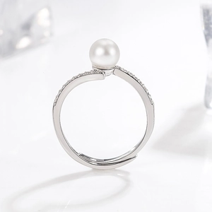 Elegant silver open ring featuring a lustrous round pearl and shimmering pavé zirconia accents