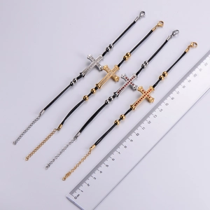 Detailed view of cross bracelets in gold and silver with rhinestones and measuring ruler
