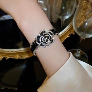 Elegant dark crystal camellia flower bracelet with sparkling rhinestones and adjustable strap