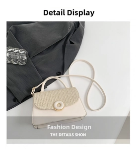 Detail of cream crossbody bag featuring faux leather, woven flap, and gold ring clasp