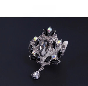 Macro detail of vintage baroque brooch with grey pear-shaped stone and AB crystals