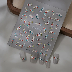 Detail of silver embossed nail art stickers with rhinestones and finished bohemian nails