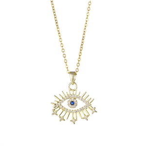 Golden Turkish Evil Eye necklace with blue gemstone and sparkling zircons on white backdrop
