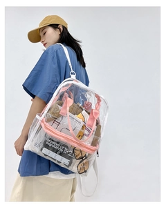 Detailed view of clear PVC backpack with pink straps and handles on model