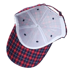 Inside view of plaid cotton baseball cap showing internal stitching and adjustable strap