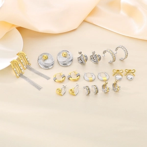 Detailed close-up of mixed gold and silver heart earrings on a soft satin background
