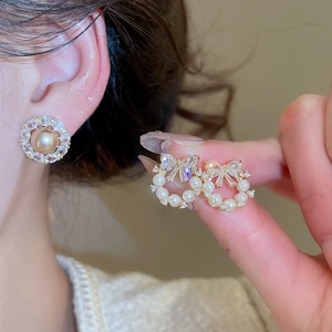 Sparkling zircon bow and pearl stud earrings with elegant gold-plated finish