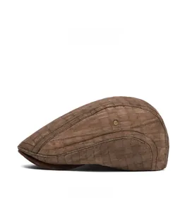 Detail view of brown plaid flat cap featuring side brass ventilation eyelets