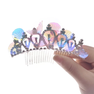 Detailed view of mermaid shell crown with iridescent rhinestones and pearls hair comb
