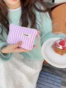 Pink and white striped cosmetic pouch for lipstick with a convenient wristlet strap
