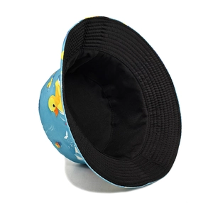 Light blue bucket hat with yellow duck print and reversible black lining for sun protection