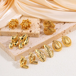 Set of vintage 18k gold plated titanium earrings featuring pearls and twisted metal designs