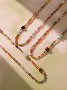 Artistic close-up of tiger eye stone and colorful faceted zircon beaded choker necklace