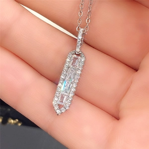 Macro shot of a silver geometric pendant necklace featuring micro-pave cubic zirconia